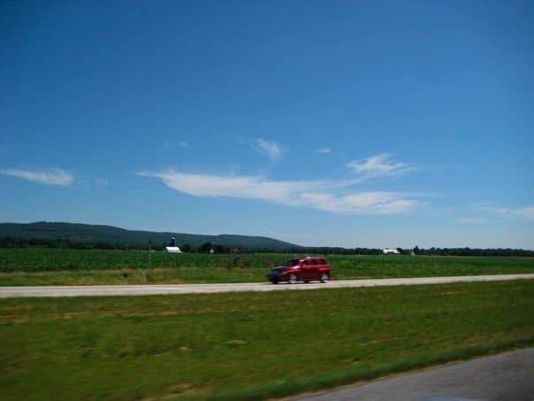 A car speeds through the summer heat on a southern road.